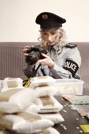 Lot of narcotics found in dealer's hiding place and seized by police staffの写真素材