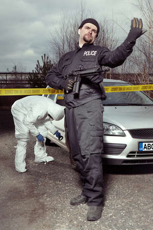Crime scene investigation - police officer guarding place of investigationの写真素材