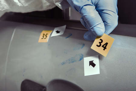 Crime scene investigation - documenting of latent fingerprint on car