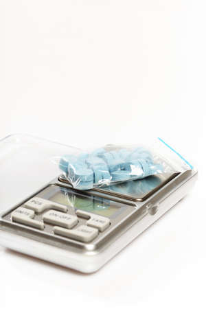 Pills of MDMA synthetic drugs on small digital scaleの写真素材
