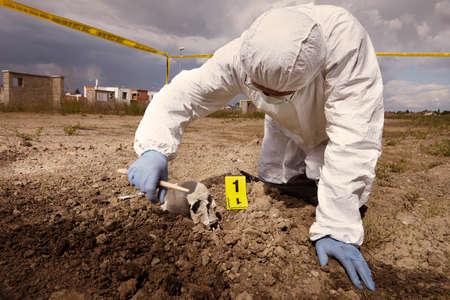 Uncovering of human skull found on plain construction yard during work