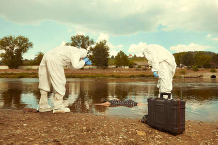 Woman body in black apparel found drowned near summer river bank in cityの写真素材