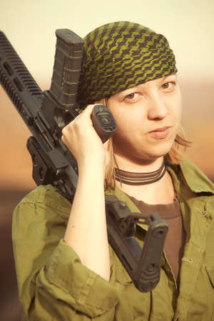 Guerilla, partisan or territory army lady watching around armed with gun