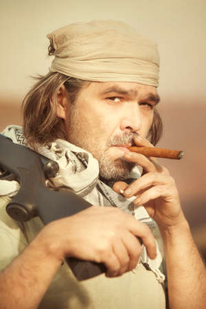 Guerilla, partisan or territory army man watching around armed with guns