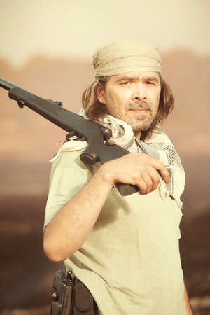 Guerilla, partisan or territory army man watching around armed with guns