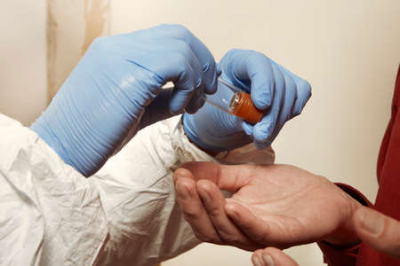 Proccess of collecting possible gunshot residue from suspected man indoorの写真素材