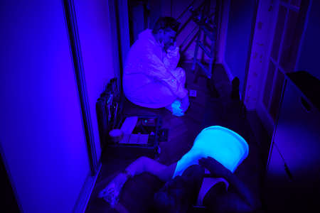 Checking place of unusual man death in ultra violet lightの写真素材