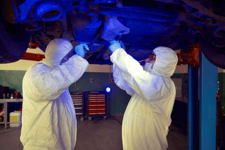 Crime investigation - collecting of evidences and traces from chassis of suspected car in police...