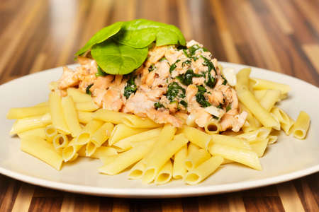 Tasty healhy meal made of pasta, salmon and spinachの写真素材