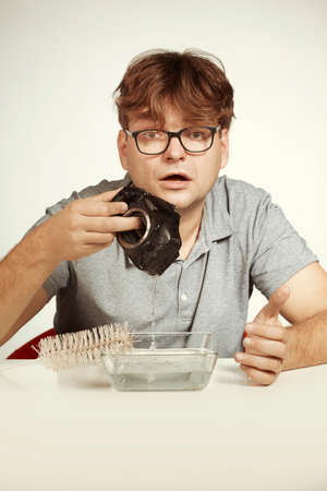 Crazy technician cleaning digital camera bad way in waterの写真素材