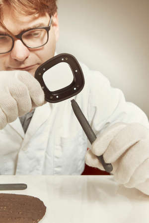 Scientist in museum office working on cuneiform findの写真素材