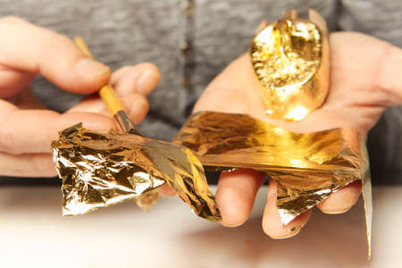 Artwork of gilding - covering an object with plate metal goldの写真素材