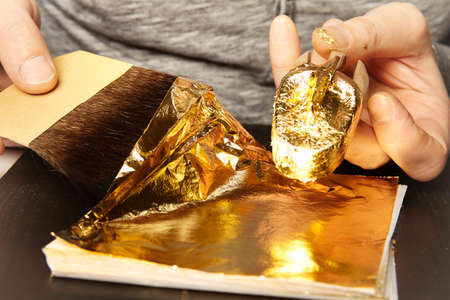 Artwork of gilding - covering an object with plate metal goldの写真素材