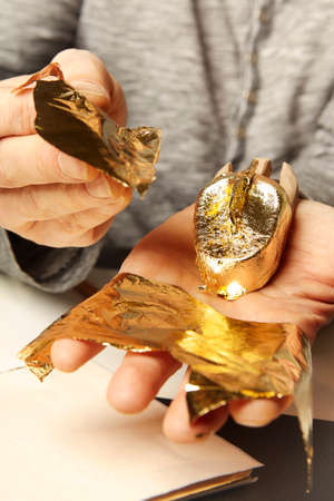 Artwork of gilding - covering an object with plate metal gold
