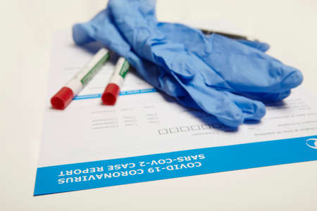 Gloves and swabs on form used for reporting of covid-19 coronavirus case