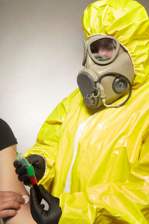 Specialist in virus protective suit holding sterile blood sample secured for testing