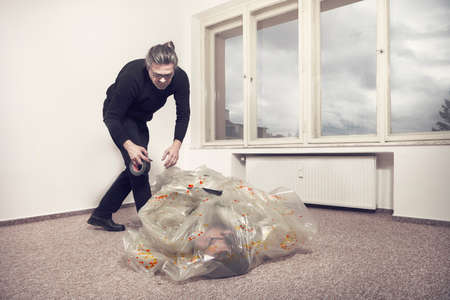 Liquidation of the drug dealer by cheated client in empty apartmentの写真素材