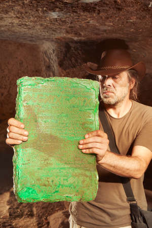 Detail of mysterious artifact emerald tablet found by adventurer in cave