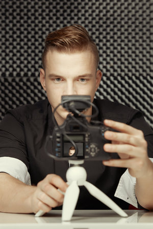 Young vlogger during process of streaming his video to public