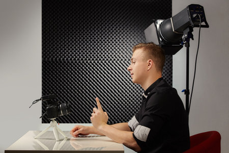 Young vlogger during process of streaming his video to public