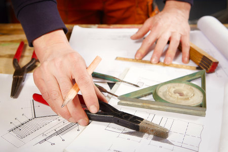 Detail of tools, folding meter, inclinometer and drawing on table