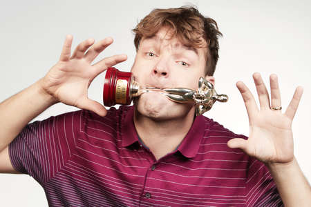 Adult man in striped dress posing with trophyの写真素材