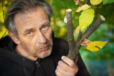 Finding of proper wooden branch for making of traditional slingshotの写真素材