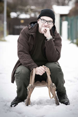 Adult man enjoying winter with classic retro wooden water slideの写真素材