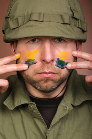 Man expressing respect to Ukraine with national colors on faceの写真素材