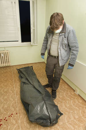 Crime scene investigation - dead man placed in body bag