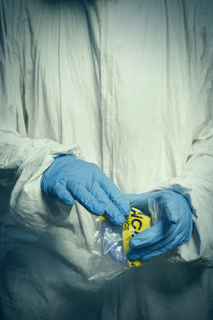 Criminologist technician sealing evidence from vacuum and micro filterの写真素材