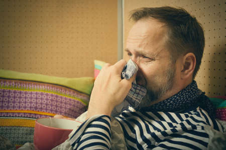 Mature sick man take care of himself alone at home in bed