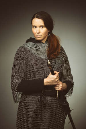 Medieval infantry armed woman dressed in chain armorの写真素材