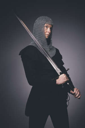 Medieval infantry armed woman dressed in chain armor