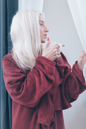 Pretty blonde lady enjoying her day and off at homeの写真素材