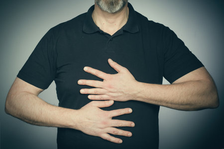 Hands of aging man trying expressions in studio in black shirt