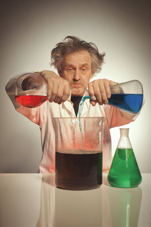Older crazy chemist preparing a chemical experiment with some liquids