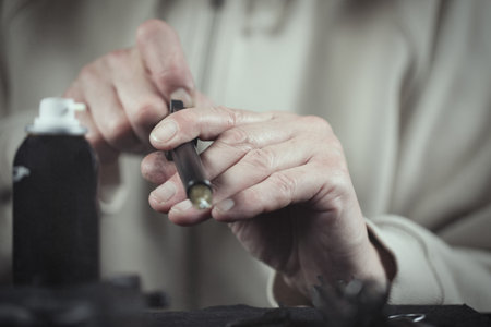 Man takes care of semi automatic pistol handgun at homeの写真素材