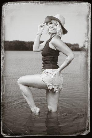 Pretty lady in summer lake posing for portrait in daytimeの写真素材
