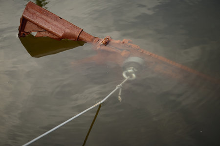 Senior citizen fishing with magnet in city lake found gunsの写真素材