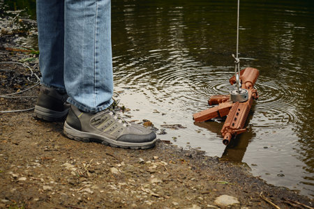 Senior citizen fishing with magnet in city lake