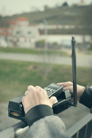 Older man outdoor on bridge using cellphone to callの写真素材