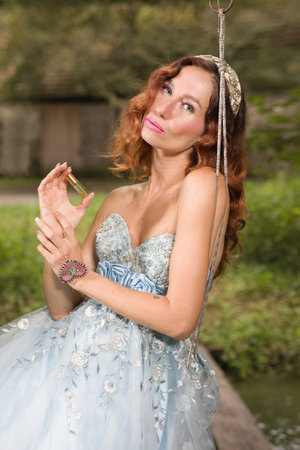 Pretty woman in nice apparel posing on countryside locationの写真素材