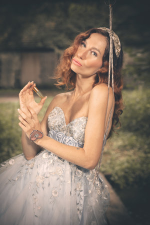 Pretty woman in nice apparel posing on countryside locationの写真素材