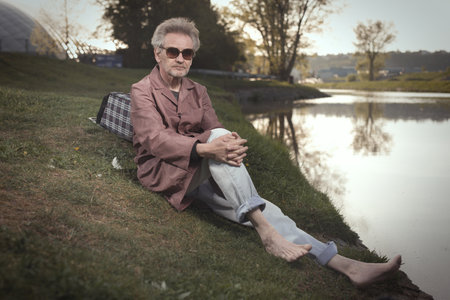 Senior citizen spending time alone in spring parkの写真素材