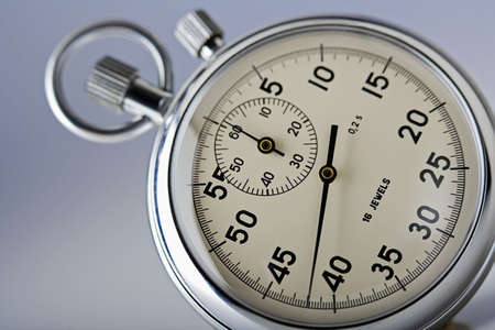 close-up of a stopwatch isolated on gray backgroundの写真素材