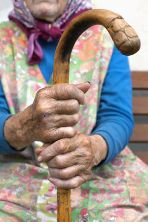 hand of an old peasant woman holding a walking stickの写真素材