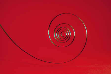 metallic spring shot against colorful backgroundの写真素材