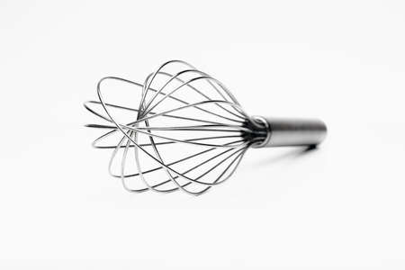 closeup of silver whisk isolated on white background