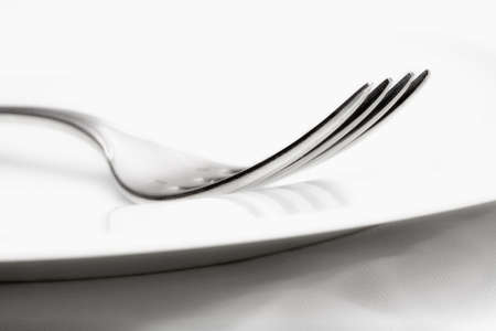 elegant table setting with silverware and plate-closeup of a forkの写真素材